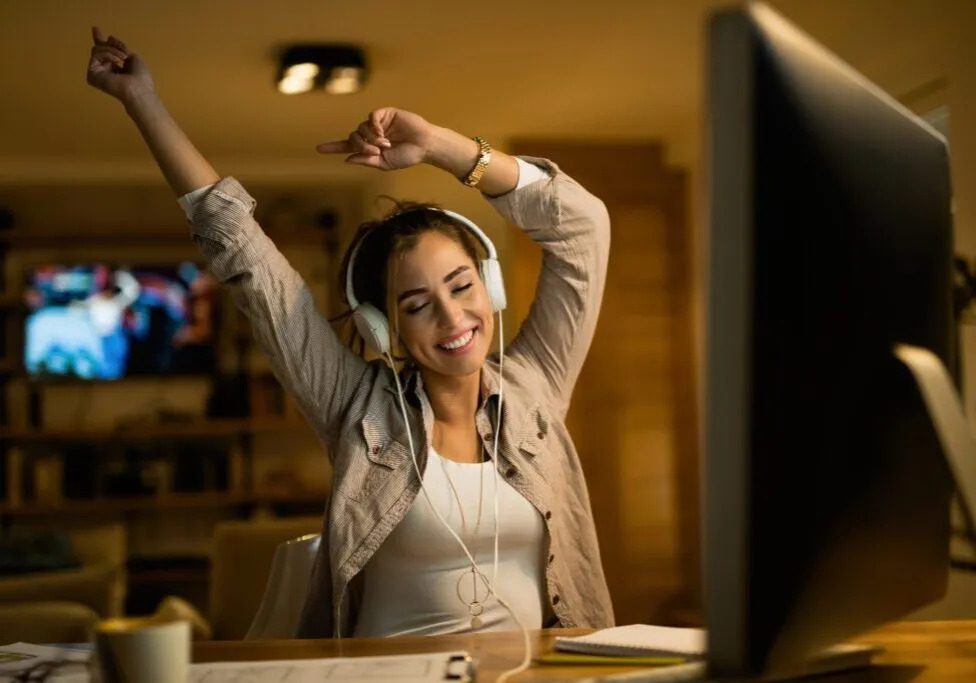 carefree-woman-listening-music-with-eyes-closed-while-using-computer-evening-home-1024x683-landscape.jpg-ezgif.com-webp-to-jpg-converter